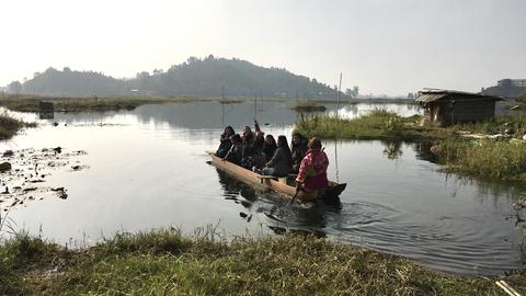 Dug-out canoe ride to and from the floating hut
