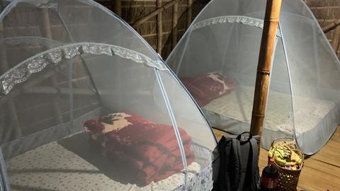 Sleeping arrangements complete with mosquito nets inside the floating huts
